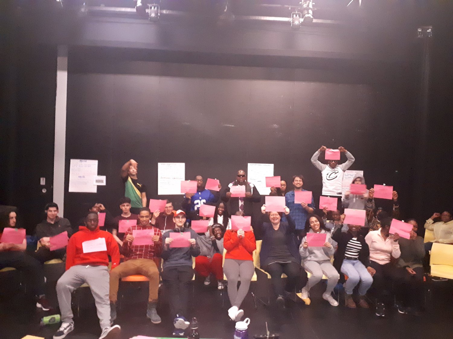Mer Bleu College students holding up colourful cards